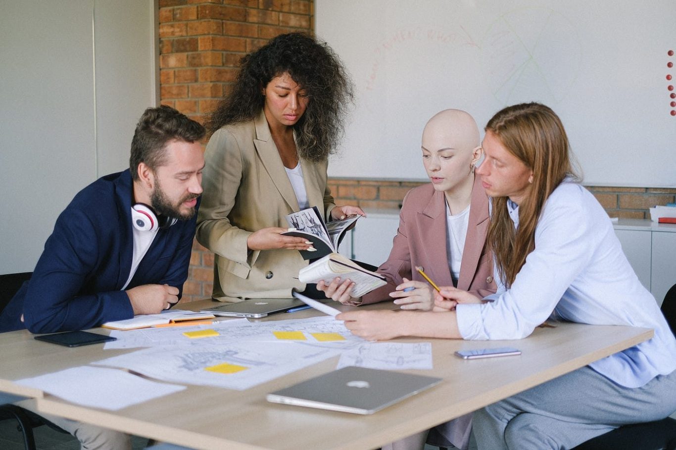 Team reviewing project material around a table